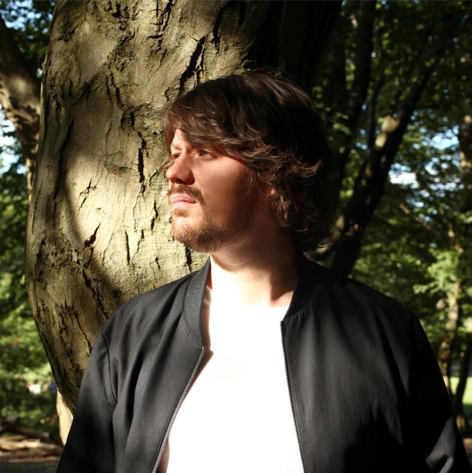 Portrait of Niclas Silver outdoors beside a tree